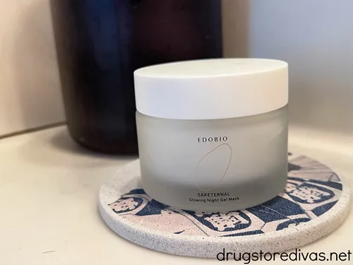A round container of night cream on a ceramic Japanese holder.