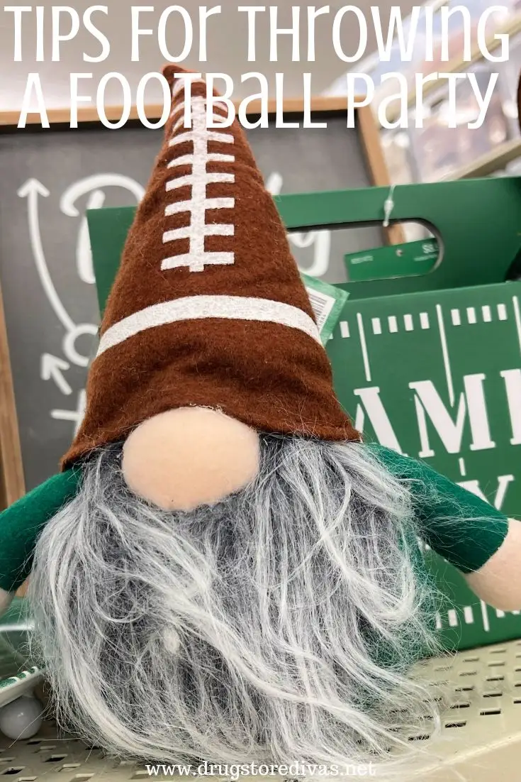 A gnome with a football hat in front of some other game day decor and the words 