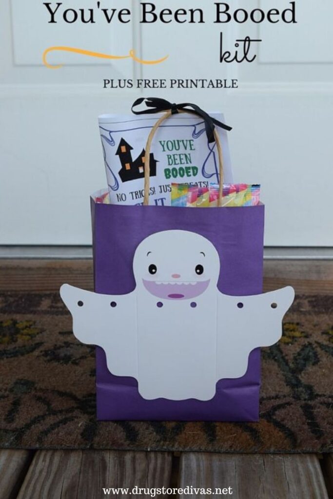 A You've Been Booed kit, which is a purple bag with a ghost on the front filled with candy,