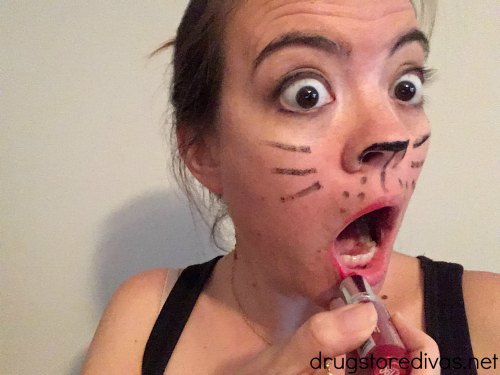 A woman with cat makeup on.