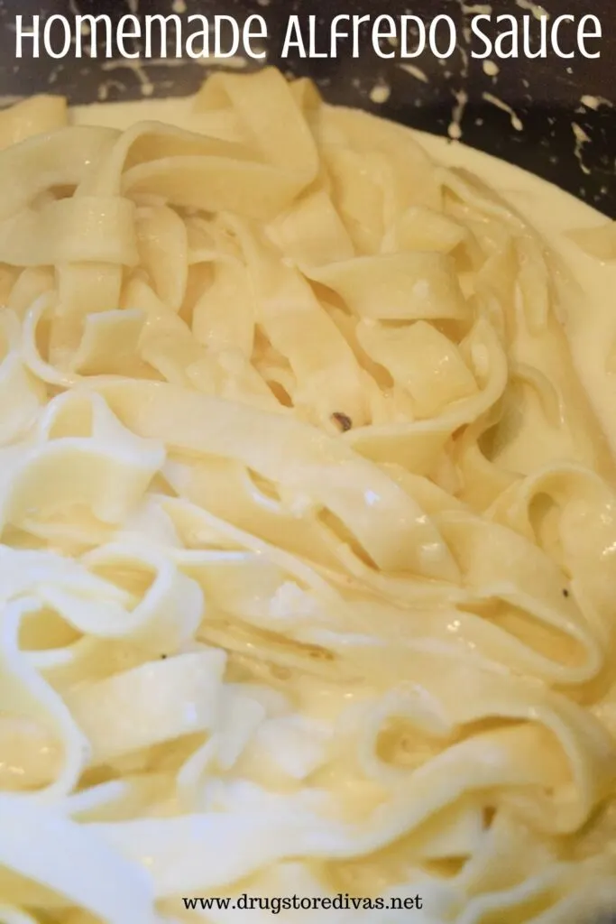 A black pot with fettuccini pasta with alfredo sauce on it and the words "Homemade Alfredo Sauce" digitally written above it.