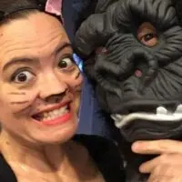 Two adults dressed up for Halloween as a cat and gorilla with the words 