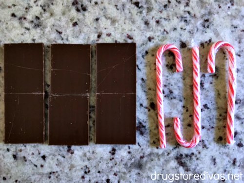 Three chocolate bars and three candy canes lined up in a row.