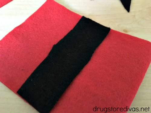 A piece of black felt on top of a piece of red felt.