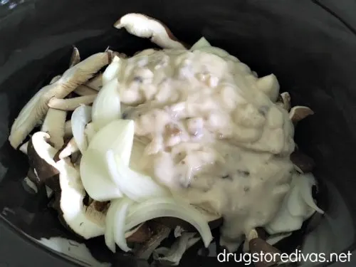 Mushrooms, onions, and mushroom soup in a slow cooker.