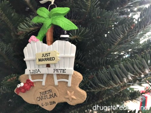 A "just married" Christmas ornament on a tree.