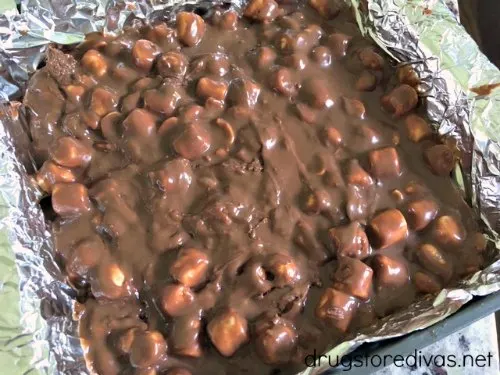 Chocolate and marshmallow fudge in a foiled lined square pan.
