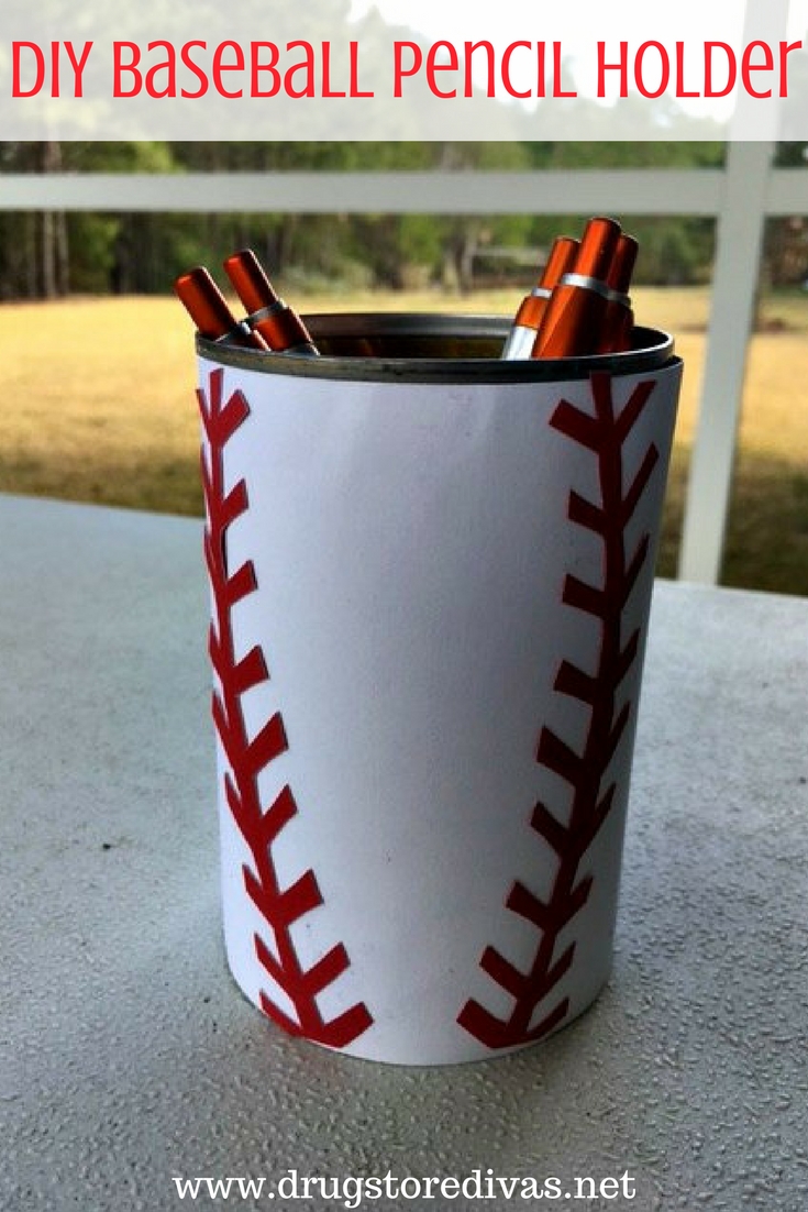 A can, designed to look like a baseball, with pens in it and the words "DIY Baseball Pencil Holder" digitally written on top.