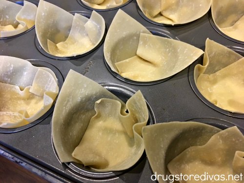 Wonton wrappers in a muffin pan.