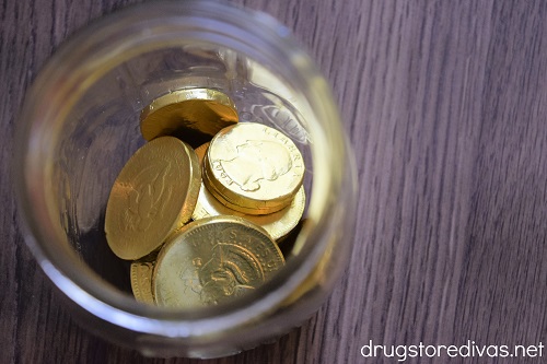 Gold chocolate coins in the bottom of a mason jar.