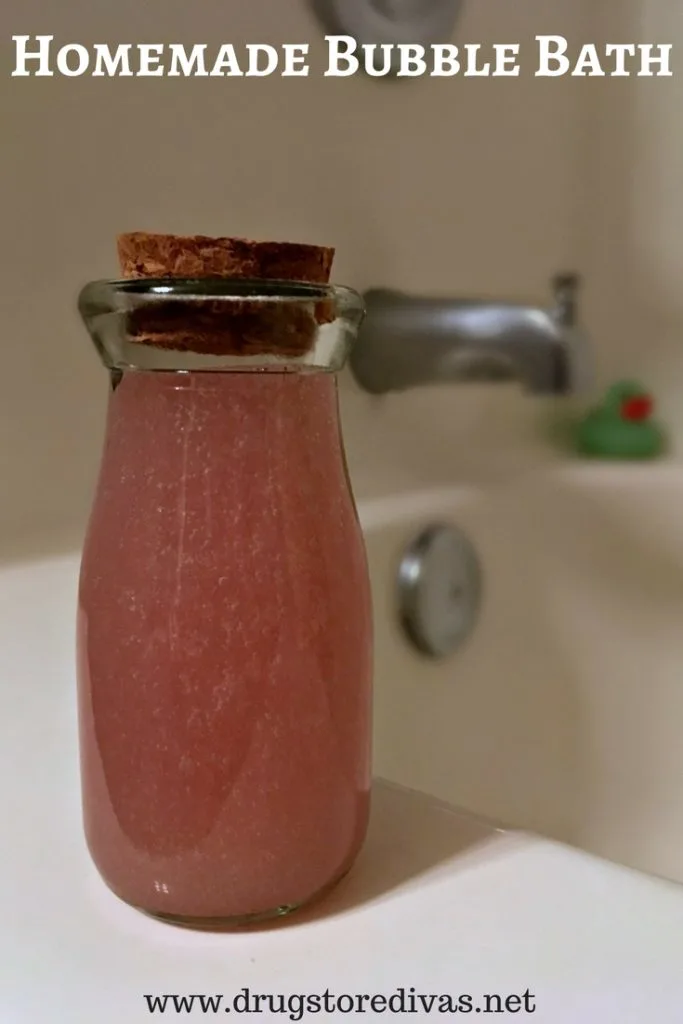 A small glass bottle of bubble bath with the words "Homemade Bubble Bath" digitally written on top.