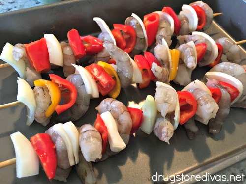 Shrimp, onions, and peppers on skewers.