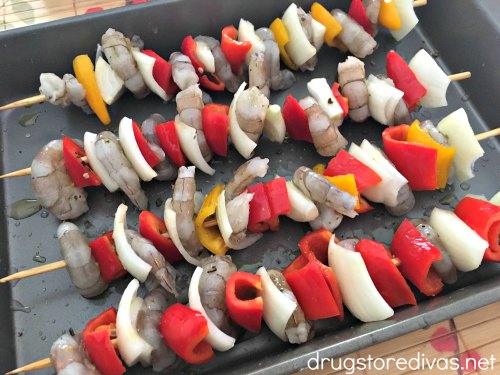 Shrimp, onions, and peppers on skewers.