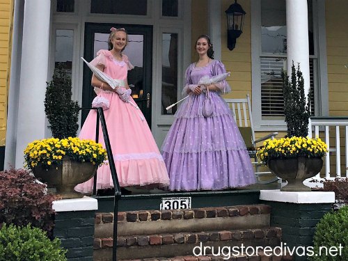 Two women dressed in antebellum attire.