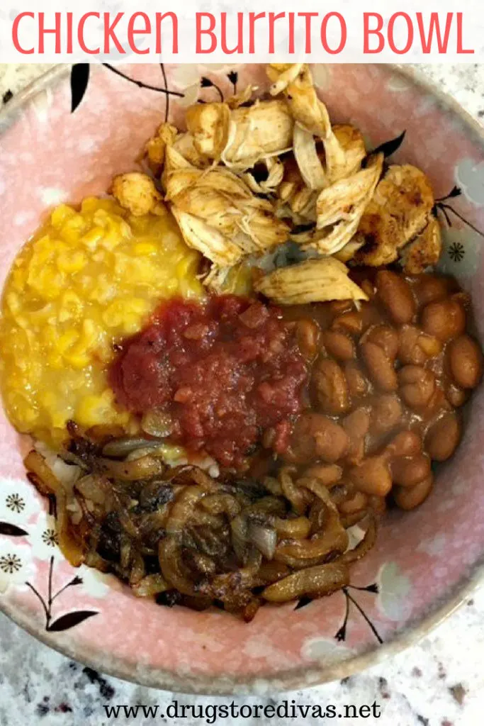 Chicken, corn, tomatoes, and beans on top of rice in a bowl with the words "Chicken Burrito Bowl" digitally written above it.