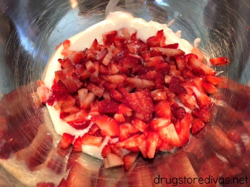 Yogurt and sliced strawberries in a bowl.