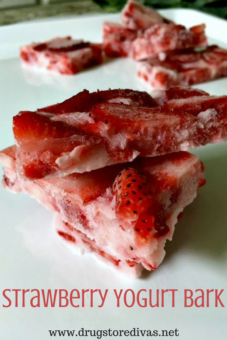 Pieces of strawberry yogurt bark stacked on a tray with the words "Strawberry Yogurt Bark" digitally written below it.