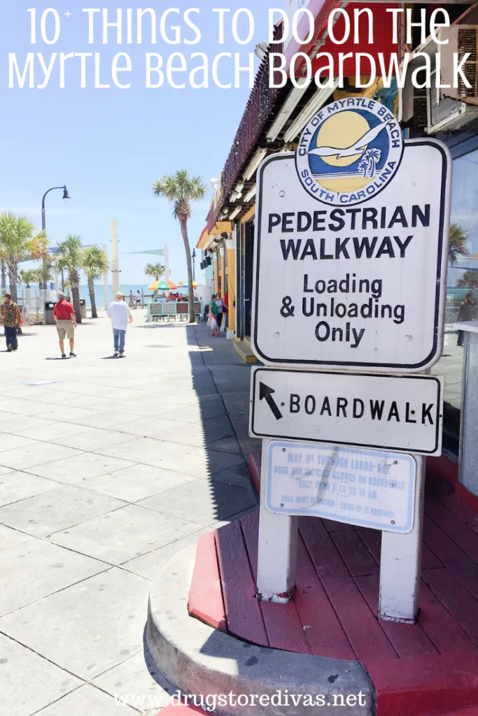 A sign pointing to the boardwalk next to people walking towards a beach and the words "10+ Things To Do On The Myrtle Beach Boardwalk" digitally written on top.