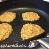 Four oatmeal pancakes in a large pan.