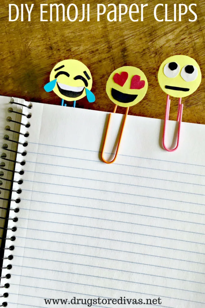 A notebook with three paperclips on it, the paperclips have emoji faces on them, and the words "DIY Emoji Paper Clips" are digitally written on top.