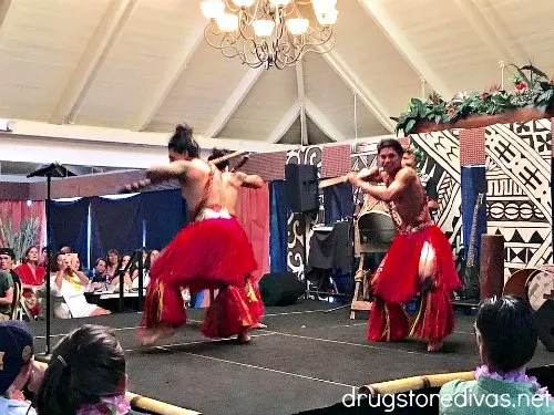 Four men performing a traditional Polynesian dance on a stage.