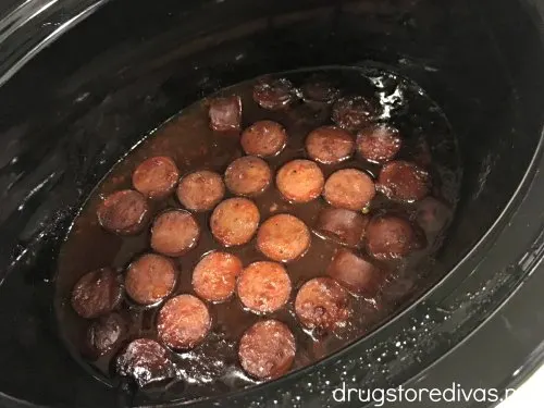 Need the perfect potluck appetizer? Go with these Slow Cooker BBQ Sausage Bites. Get the recipe at www.drugstoredivas.net.