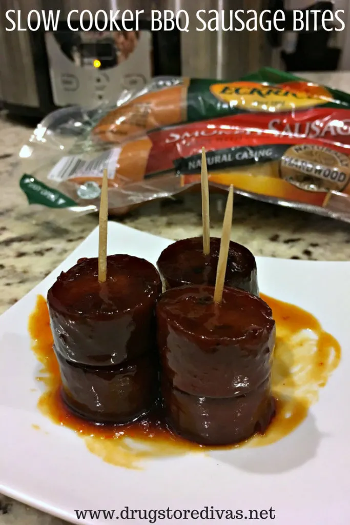 Sausage bites with toothpicks on a plate, a sausage package behind it, and a slow cooker behind that with the words "Slow Cooker BBQ Sausage Bites" digitally written above it.