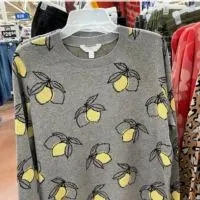 A sweater with lemons on it and the words 