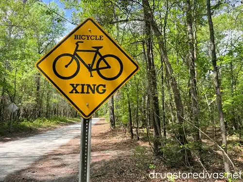 A bike crossing sign on a trail.