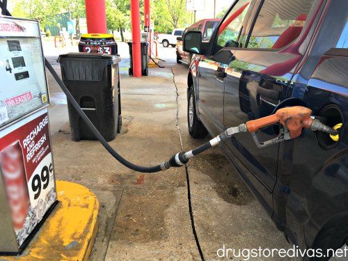 Gas pumping into a car at a gas station.