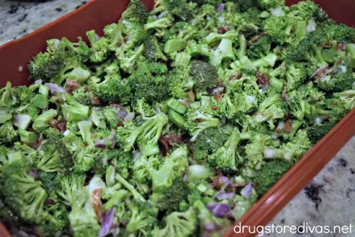 Broccoli salad in a red plastic container.
