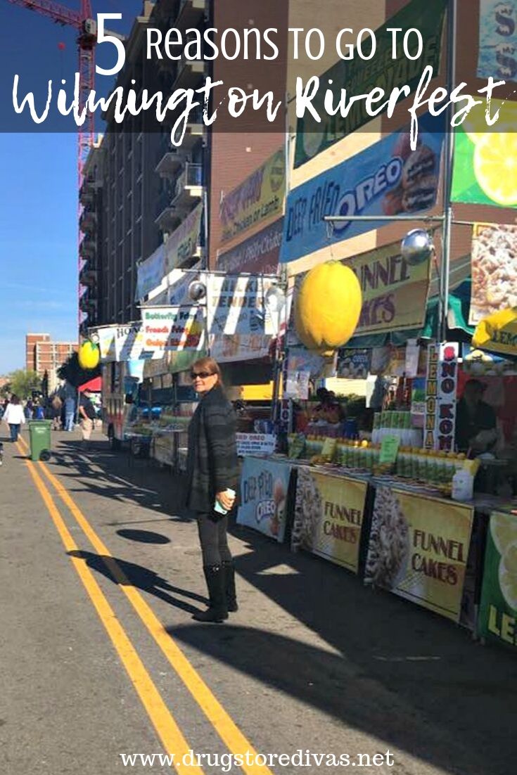 A woman standing in a street fair with the words 