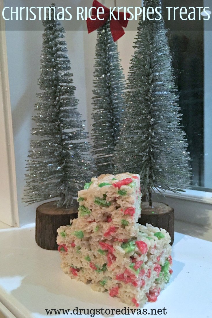 Christmas Rice Krispies Treats set in front of artificial Christmas trees.
