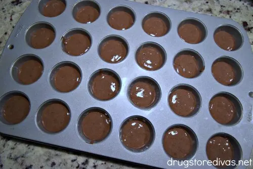 Chocolate cake mix in a mini muffin pan.