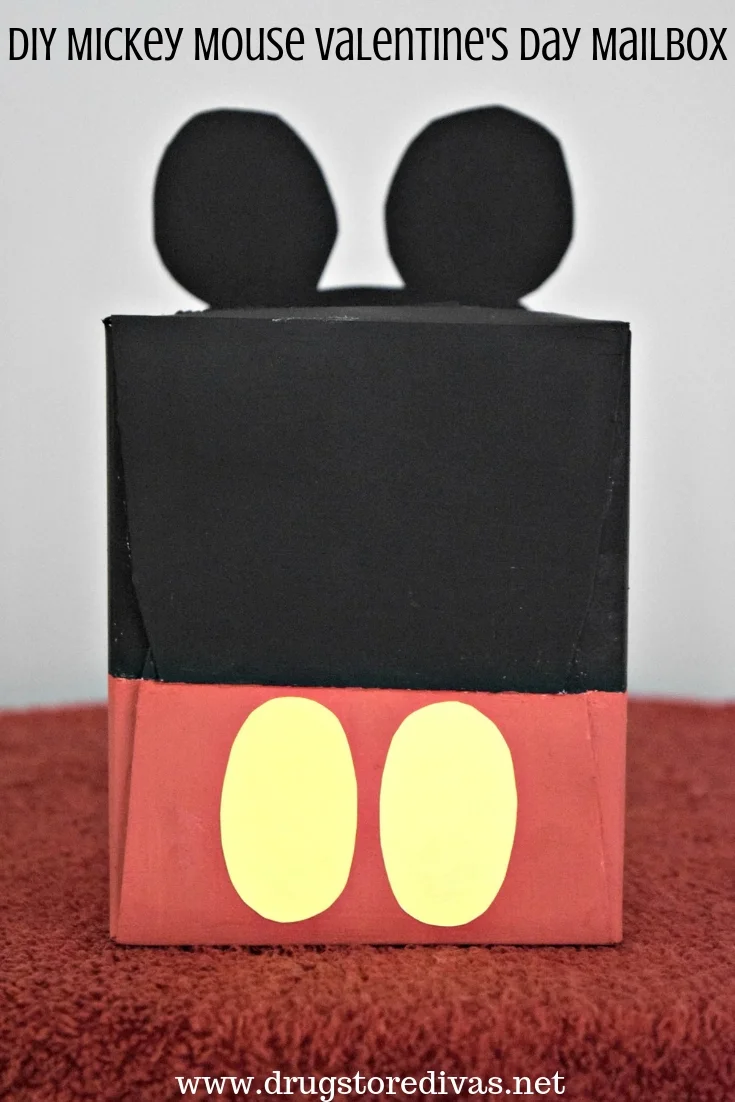 A tissue box painted to look like Mickey Mouse with the words "DIY Mickey Mouse Valentine's Day Mailbox" digitally written on top.