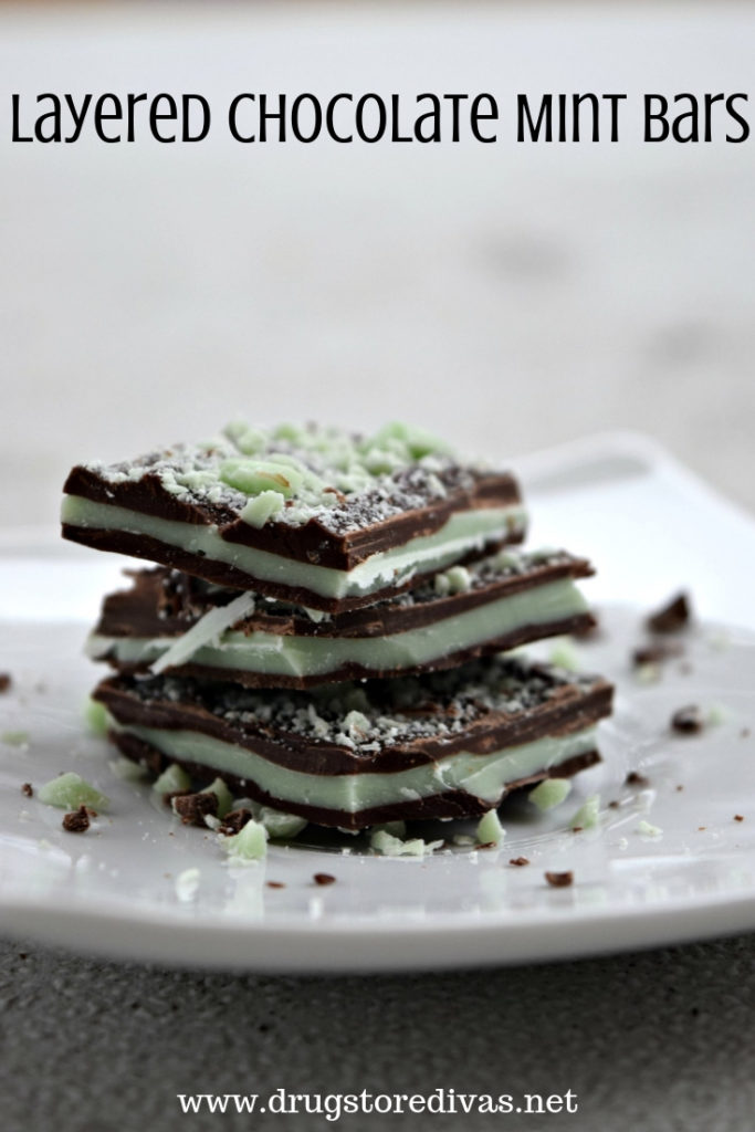 Three pieces of layered chocolate mint bars on top of each other on a plate with the words "Layered Chocolate Mint Bars" digitally written on top.