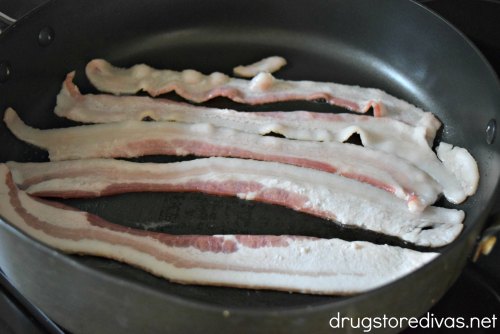 Bacon cooking in a pan.