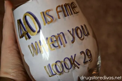 Need a gift for a 40th birthday party? Make these DIY 40 Is Fine When You Look 29 Glitter Wine Glass. Get the tutorial and printable on www.drugstoredivas.net.