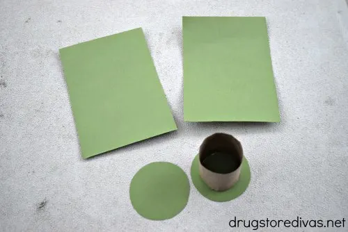 Two green rectangles, two green circles, and a piece of a toilet paper roll.