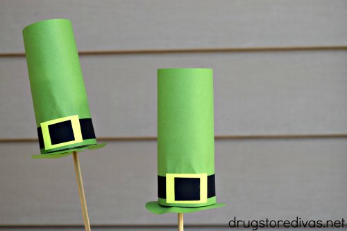 Two Leprechaun hats made out of toilet paper rolls on skewers.