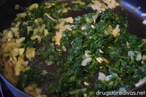 Spinach, onion, and garlic in pan.