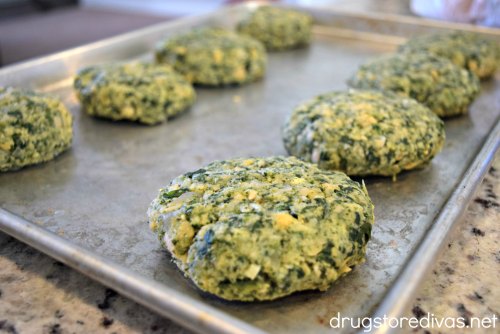 Chickpea and spinach burgers on a pan.