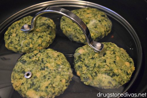 Chickpea and spinach burgers on stove.