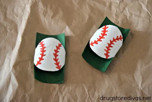 Two toilet paper rolls made to look like Baseball-Shaped Utensil Holders.