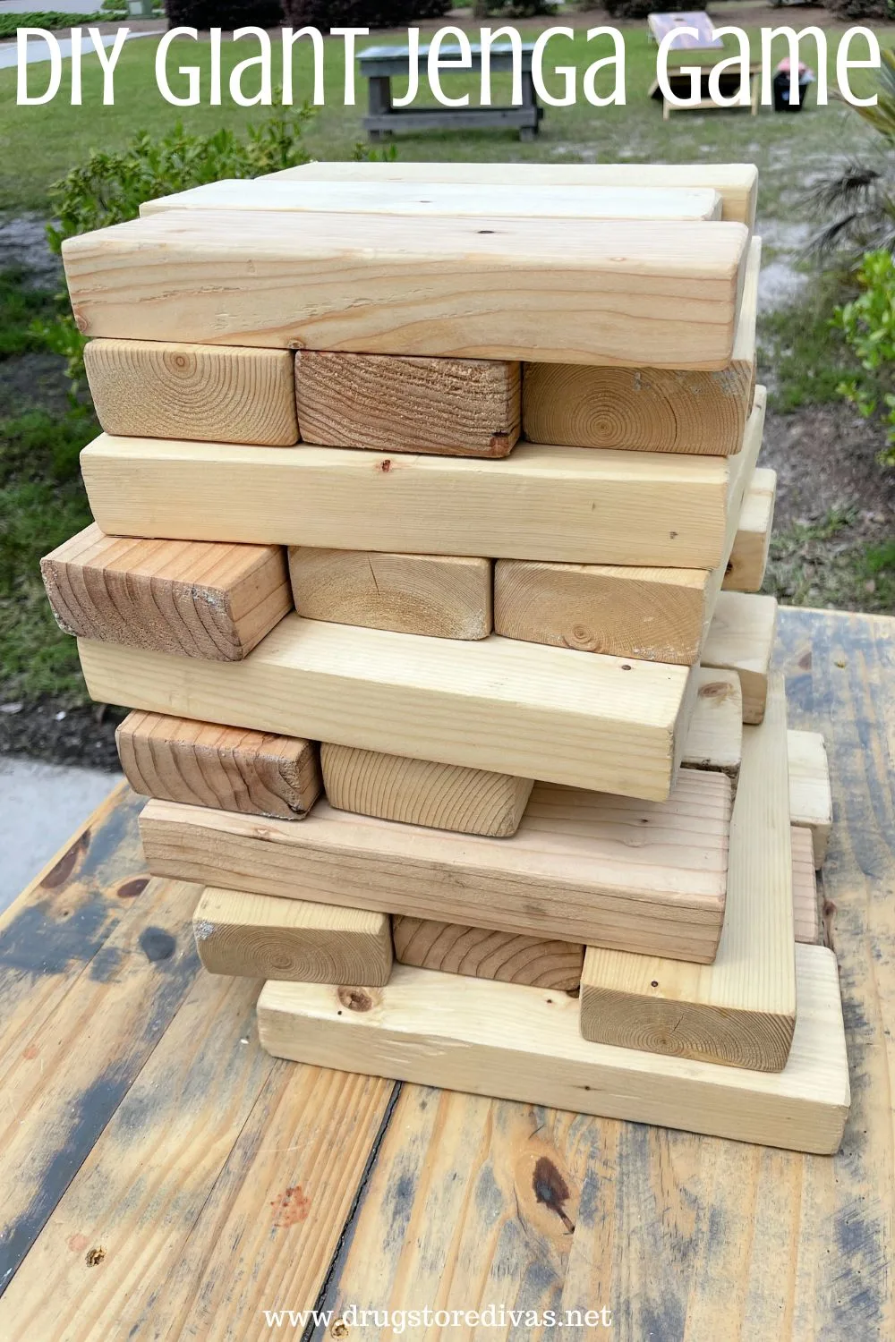 A homemade wooden Jenga game on a wooden table with the words 