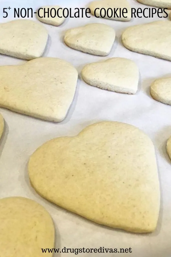 Heart-shaped sugar cookies on parchment paper with the words "5+ Non-Chocolate Cookie Recipes" digitally written above them.