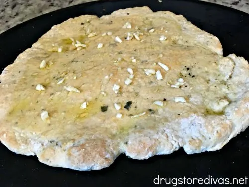Switch your frozen pizza for this 2 Ingredient Dough White Pizza. It's simple to make and SO delicious. Get the recipe on www.drugstoredivas.net.