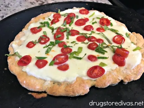 Switch your frozen pizza for this 2 Ingredient Dough White Pizza. It's simple to make and SO delicious. Get the recipe on www.drugstoredivas.net.
