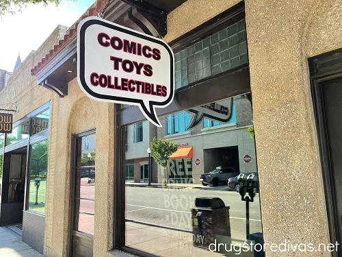 A comic bubble saying "Comics Toys Collectibles" on the side of a building.