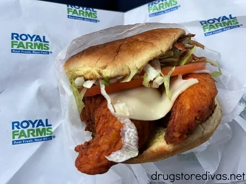 A chicken sandwich from Royal Farms chicken in a wrapper with the gas station's logo on it.
